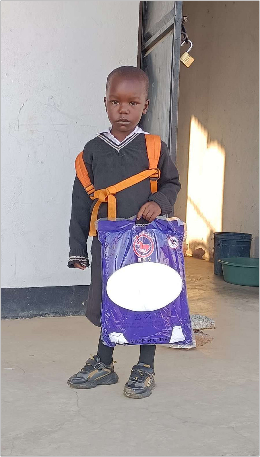 Jovin holding his mosquito net